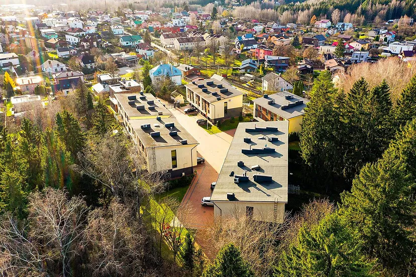 New low-rise apartment buildings among the pines, from the air