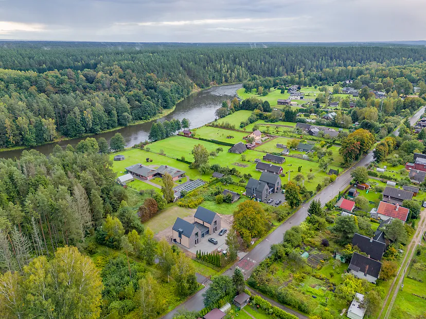 Village by a river and forest in the fall