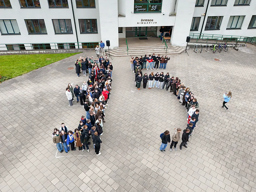 High school students seen from the air, standing in the shape of the number 35