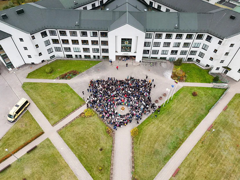 The whole high school community in the schoolyard, photographed from the air
