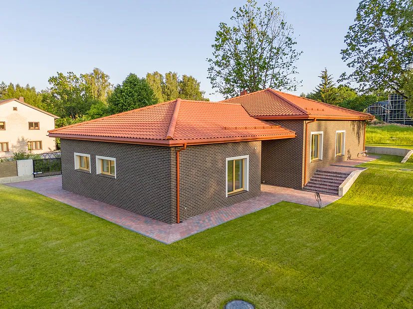House with a red roof and lawn from the air
