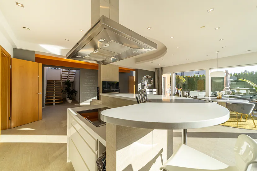Kitchen with an island and a range hood