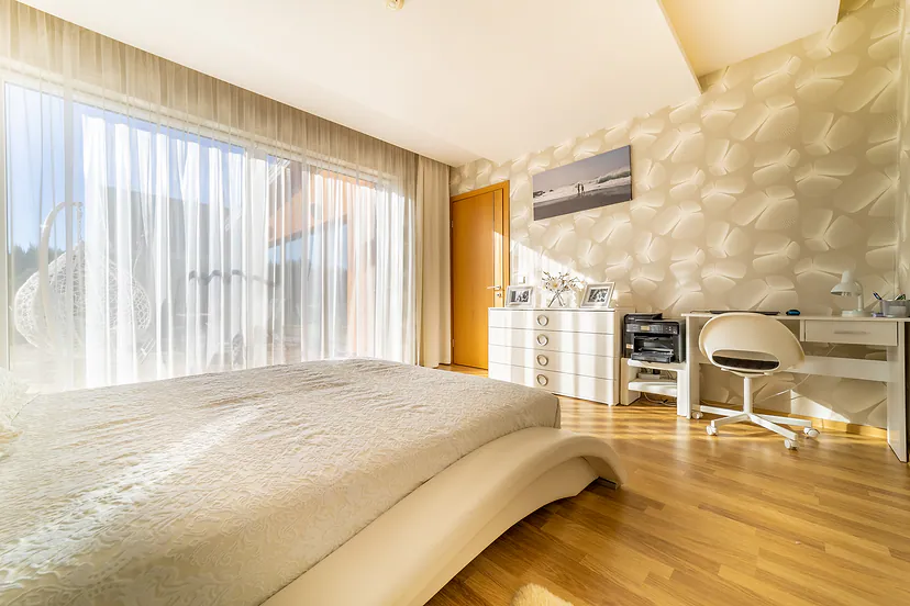Bedroom with a desk by the window