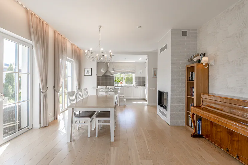 Dining room with a fireplace and an upright piano