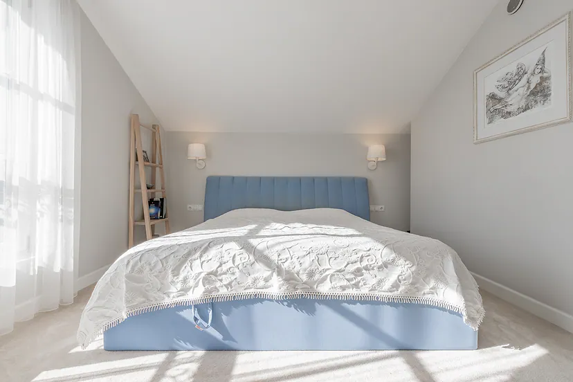 Bedroom with a pale blue bed