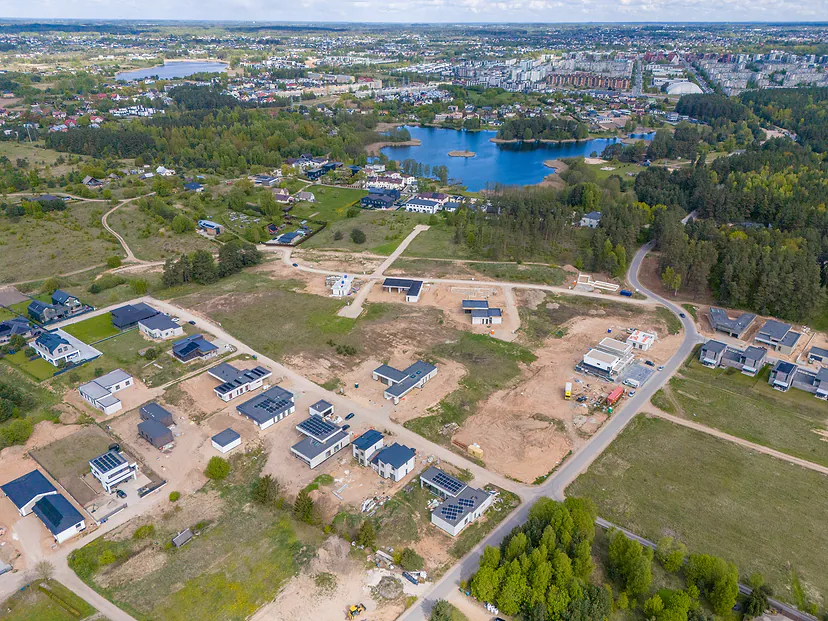 New plot development from the air, a lake and the city in the background