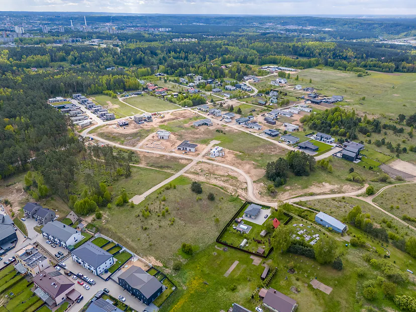 New streets and houses under construction by a pine forest