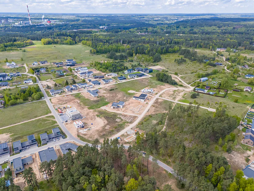 The development from the air, forest in the foreground