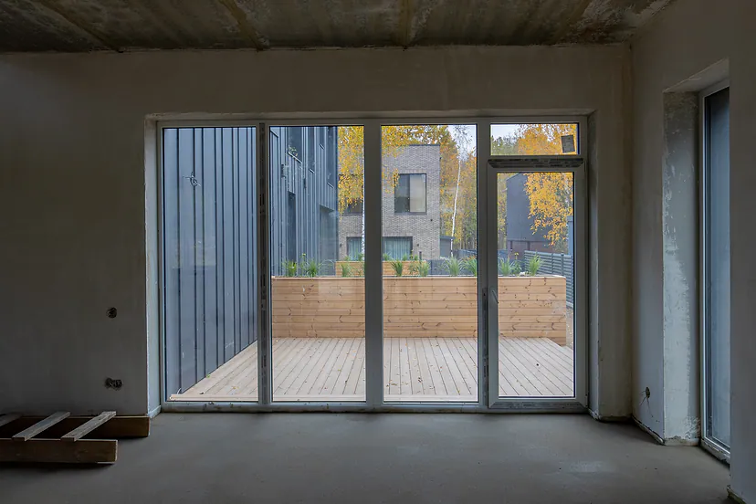 Room with a partial finish and a door to the terrace