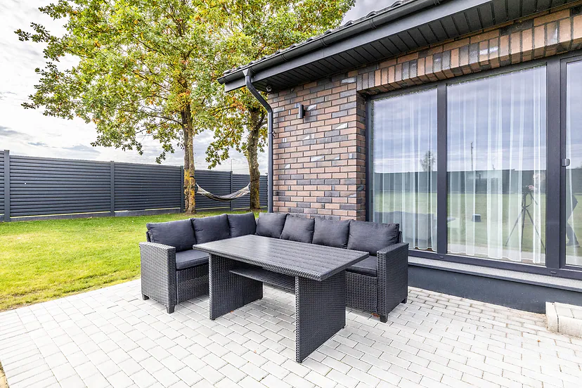 Terrace with outdoor furniture by the large windows