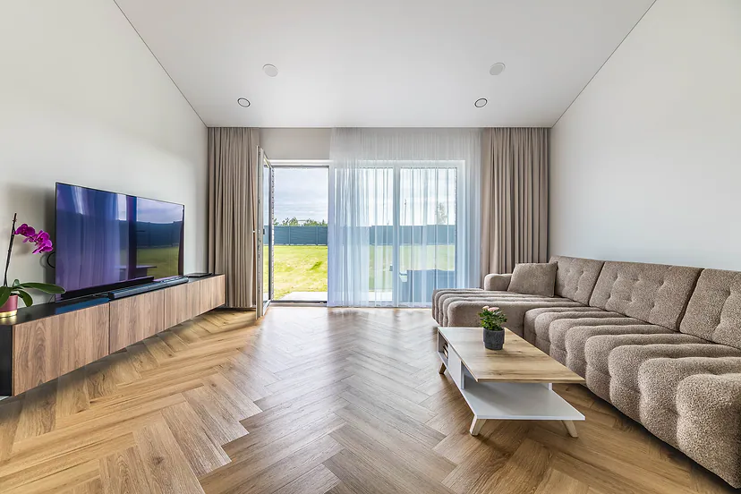 Living room with a TV and a door to the yard