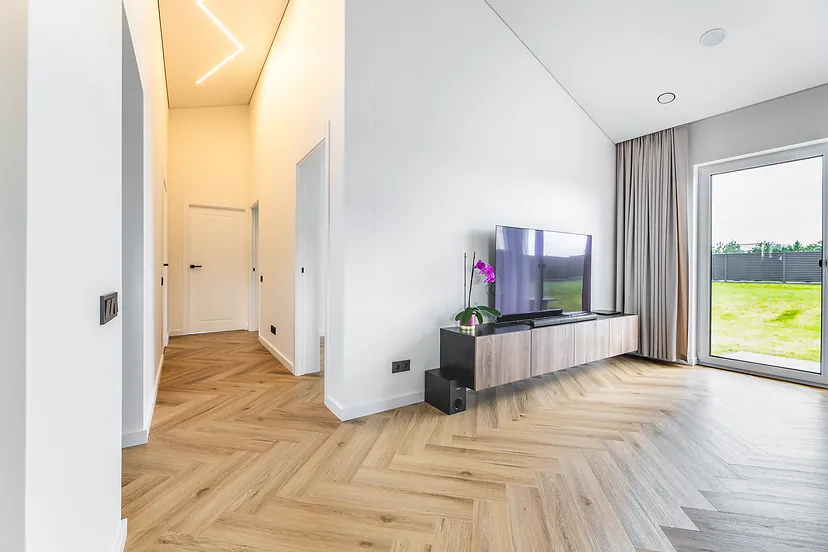 Living room and a hallway with a light strip in the ceiling