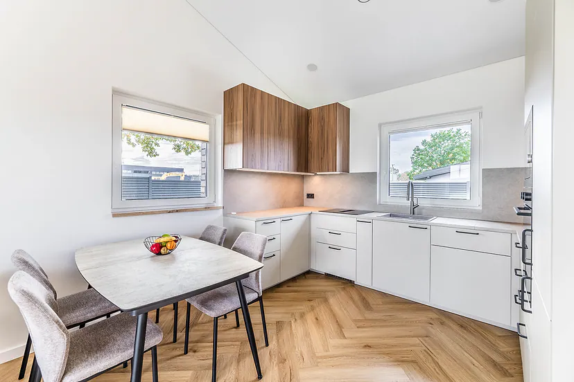 Kitchen with a dining table and two windows