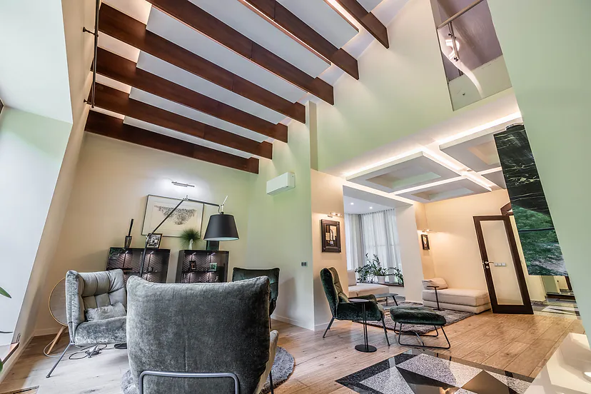 Living room with beams in the ceiling and large windows