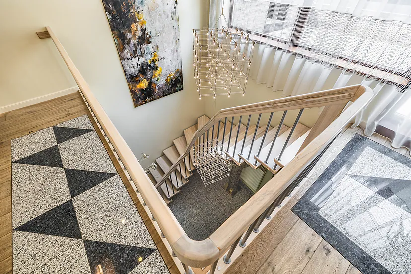 The stairs from above and a crystal chandelier