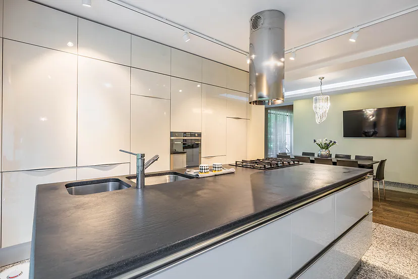 Kitchen with a long island and white cabinets