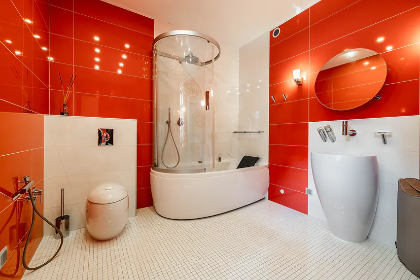 Red bathroom with a round shower cabin