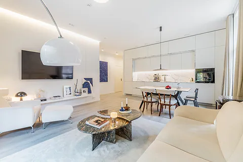 Bright living room with a kitchen, a marble coffee table and a dining table