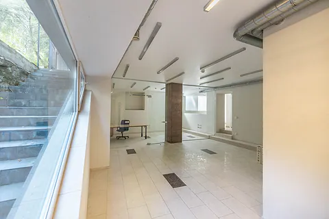 Bright commercial space with glass partitions and tiled floors