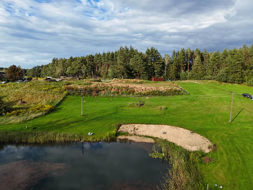 Sand landslide by a pond and meadow, photos for court