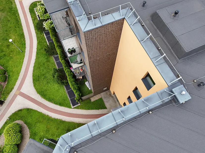 Apartment building roof, yard and paths, view straight from above