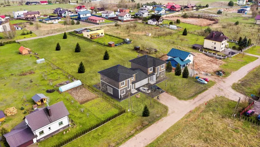 Two new houses among homesteads, visualization in an aerial photo