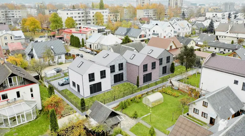 Two new houses in town among old houses, aerial visualization
