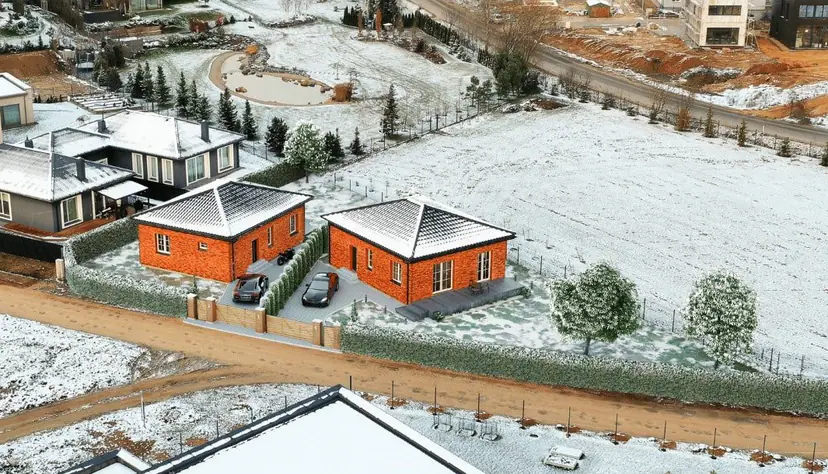 Two brick houses in winter, visualization in a snowy aerial photo