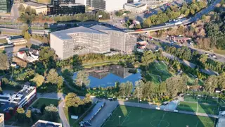 Office building by a pond at sunrise, filmed by drone (3)