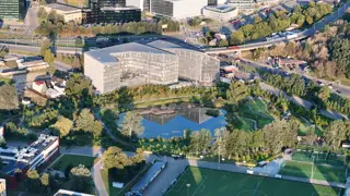 Office building by a pond at sunrise, filmed by drone (4)