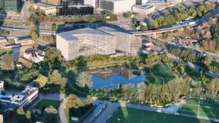 Office building by a pond at sunrise, filmed by drone (5)